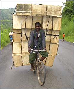 A man in Burundi rides a bicycle laden with boxes