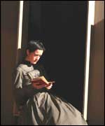 Anne sits readings as Bronte Sisters at haworth Parsonage