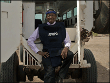 Alvin Hall standing by a van