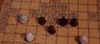 Chalk and amber playing pieces on a modern gaming board. (c) York Archaeological Trust.