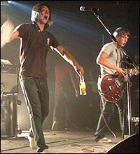 Alex swings a towel on stage