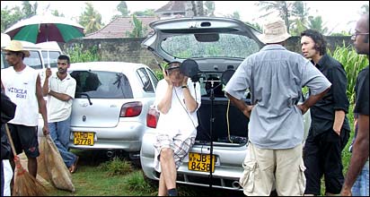 Director Willi Richards listens to playback during recording in monsoon (photo: Roger Elsgood)
