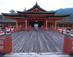 Red-painted wooden railings and building with traditional stepped roof