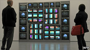 Man and woman watching art installation