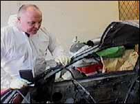 Chris examining a bombed car
