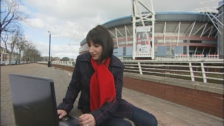 Lucy looks at her laptop outside the Millennium Stadium