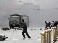 Tibetans throwing stones at army vehicle in Lhasa, Tibet