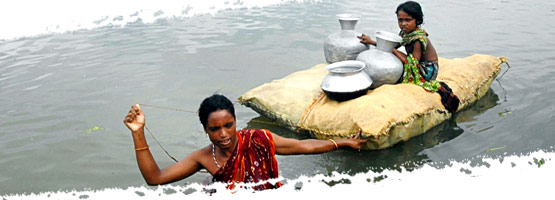 Woman into the water pulling a floating raft, with vases and a girl