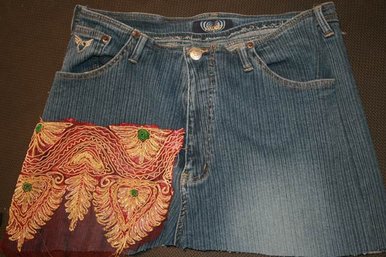 Denim skirt with gold and red motif.