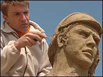 One of sculptors adds the finishing touches.