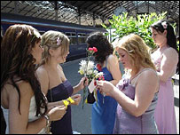 Girls in ballgowns at the train station