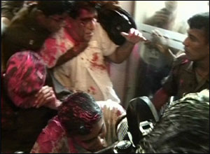 Minister Dr. Mervyn Silva being taken away by security forces