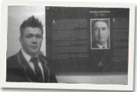 Tom James o gapel Bangor o flaen panel Coffa Vivian Jenkins yn y Ganolfan Addysg newydd yng Ngholeg Llanymddyfri. 