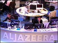 Al-Jazeera English staff prepare in their Doha news room in Qatar