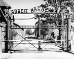 Entrance to the main camp of Auschwitz. The gate bears the motto: 'Arbeit Macht Frei' (Work makes one free). © United States Holocaust Memorial Museum (USHMM)