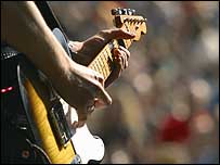 Guitar being played on a stage