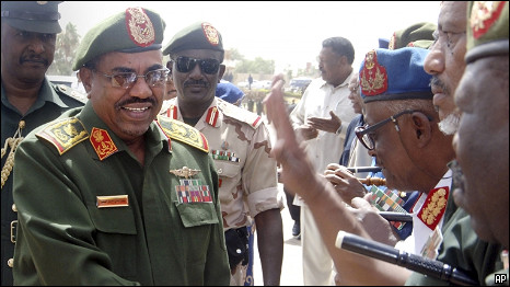 Sudanese President Omar al-Bashir greets army officers