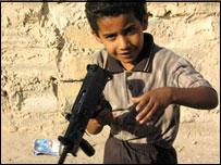 A young boy with his toy gun in Basra