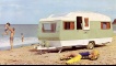 Family on a beach on holiday with their caravan