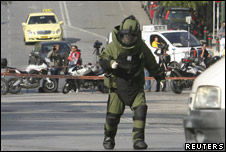 Police explosives expert arrives to detonate a suspicious package in Athens, Greece. 