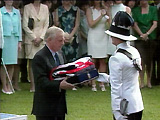 The last British Governor of Hong Kong, Chris Patten, hands the the Union Flag and the flag of the Royal Yacht Britannia to an equerry of HRH The Prince of Wales.