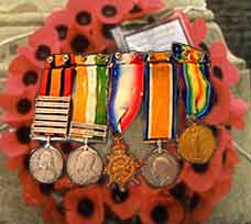 Image of soldiers' grave, decorated with war medals, from 'Military' quiz