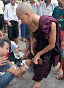 Injured monk receives treatment.