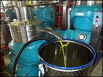 olive oil pouring out of the machine