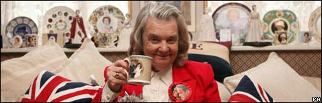 a woman with royal memorabilia including a cup of tea