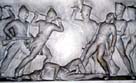 Photograph showing a wall carving dipicting a battle between British and Indian soldiers