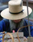 Amish man in straw hat and with a grey beard