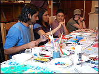 Members of Aik Saath painting on their residential