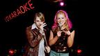 Two people singing at a Karaoke club
