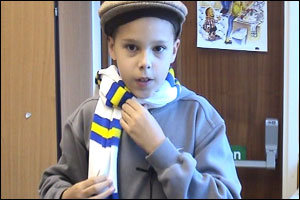 Elliot putting on a Leeds United scarf