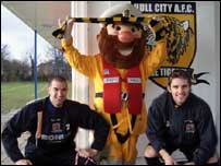 Man in costume with two football players