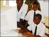 African children working at a donated computer.