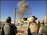 گروه متخصصان آمريکايی در بغداد بمبی را که کنار جاده کار گذاشته شده خنثی می کنند