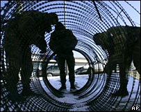 French soldiers laying razor wire on the bridge at Mitrovica