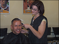 The stylist gets to work on Rob's hair