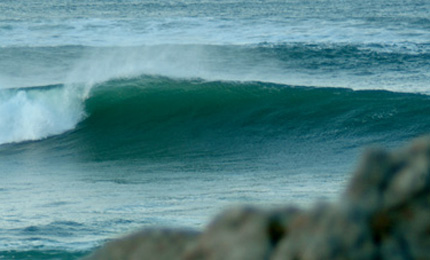 Work in progress. J hits the lens before we hit the wave. This is a new reef, fat and slow but shallow. Potential fin buster as well. Pic J Dec 06