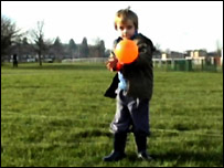 A child blows up a balloon