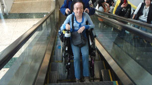 A delighted Liz finally gets her ride on the wheelchair accessible escalator in Tokyo