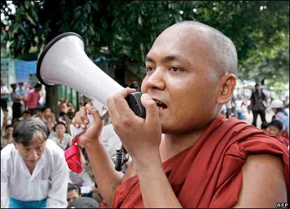 Monks and civilians sit at the Shwedagon Pagoda in Rangoon. 