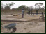 Sohm building site with wheelbarrow an locals.