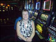 Woman sitting at fruit machines