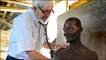 Dr Fournier with a patient in Haiti