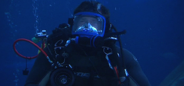 Steve Backshall wearing scuba gear in a shark tank