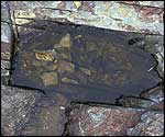 A hole cut in the rock where gold could be found