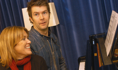 Rhod picks out the tune on the piano