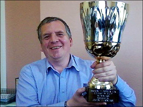 Man holding football trophy 470